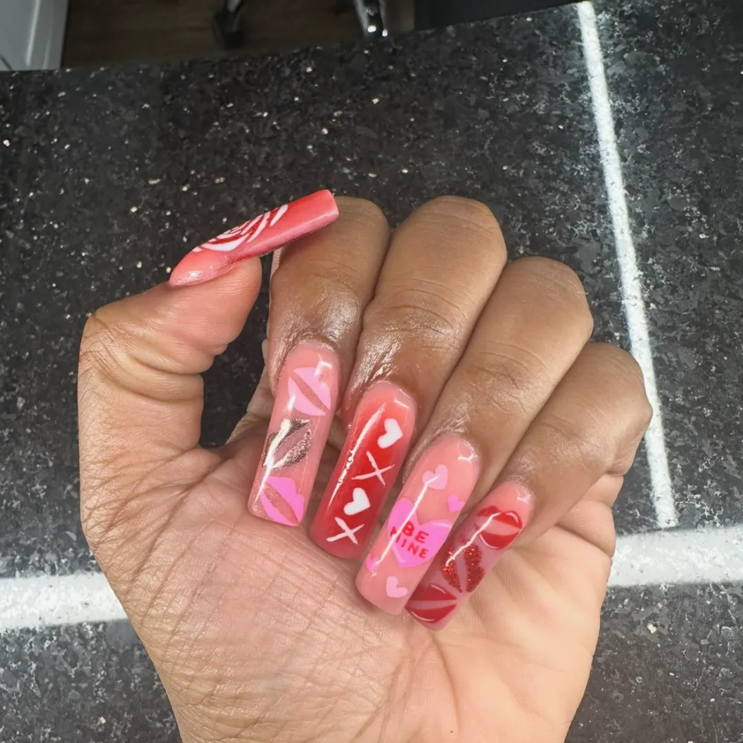 Valentine's themed pink and red nails with hearts and lips