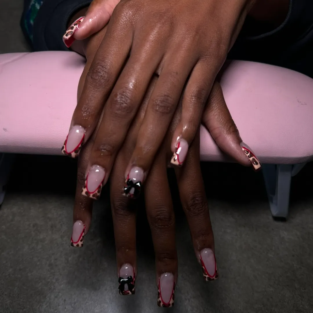 Red and leopard print French tip nails with 3D bows