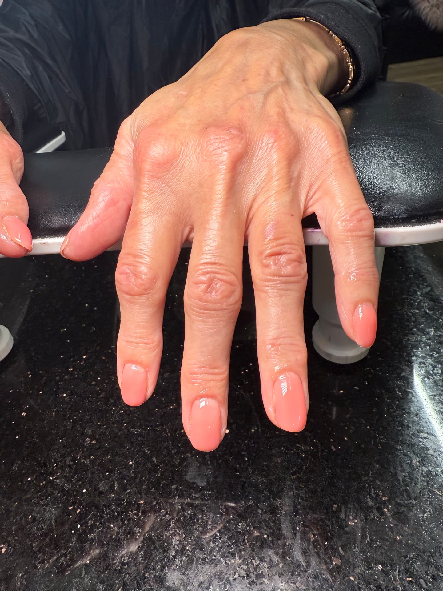 Clean, glossy peach-pink natural manicure on short nails