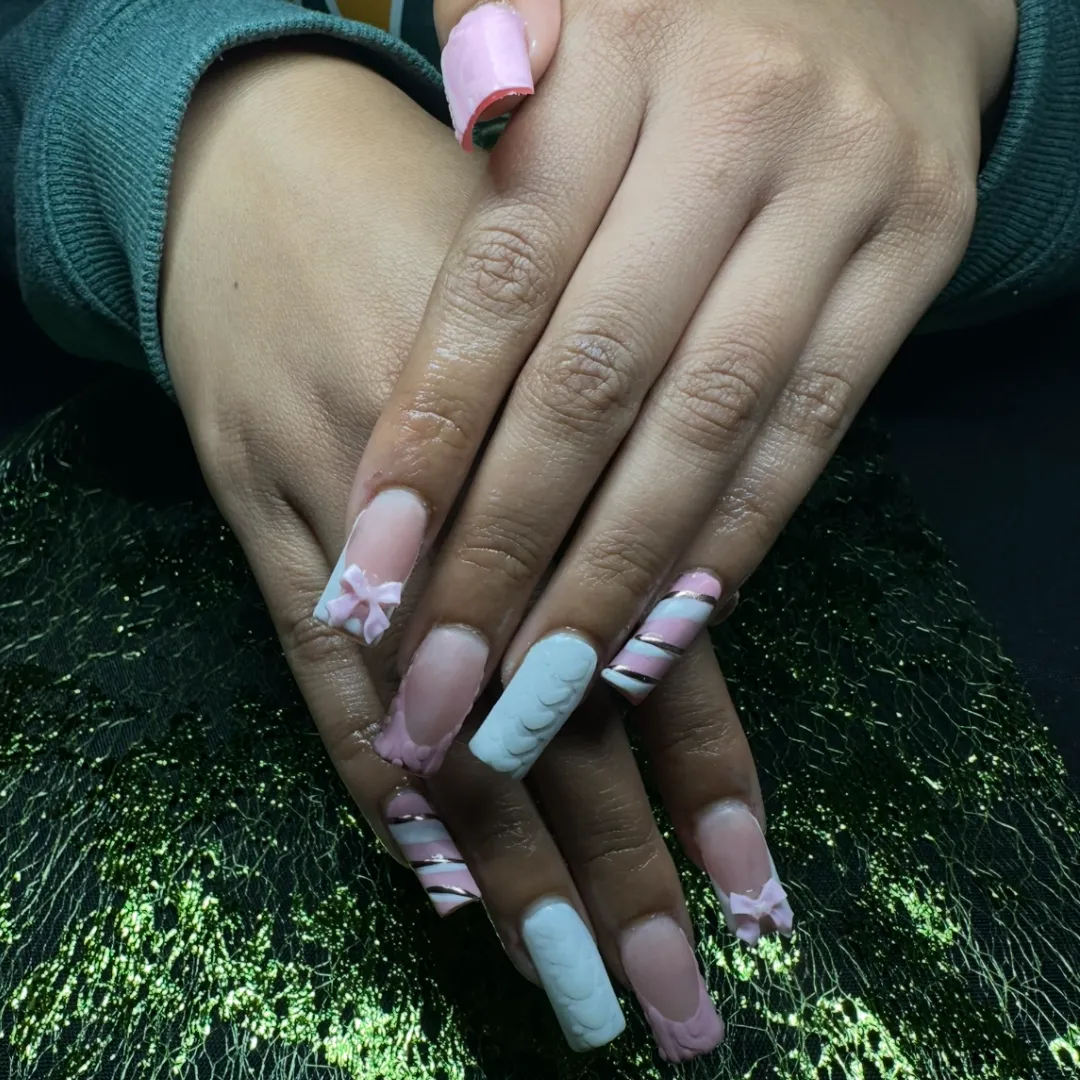 Pink and white candy stripe nails with 3D bows and chrome accents