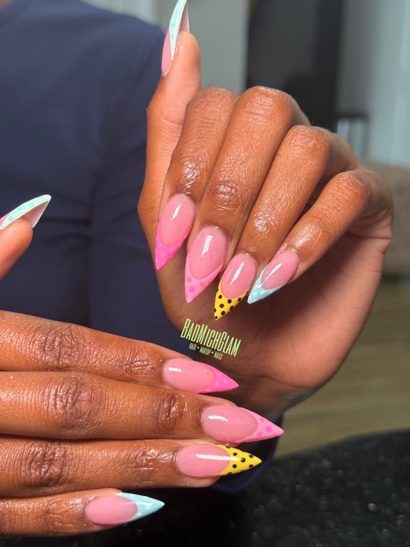 Long stiletto nails with pink, yellow and blue French tips and polka dots