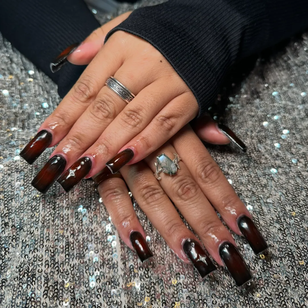 Long dark cherry mocha nails with star accents
