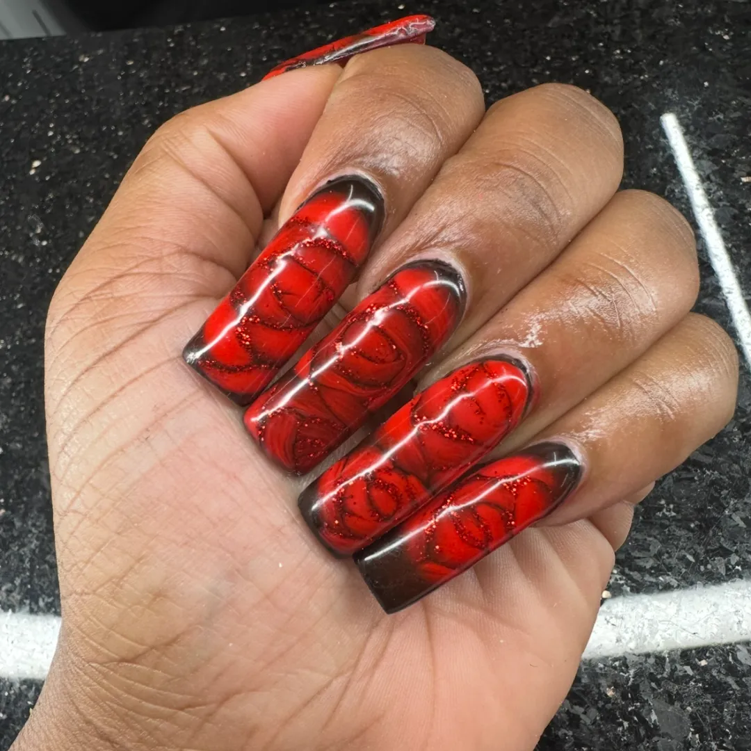 Long coffin nails with red and black marbled glitter art