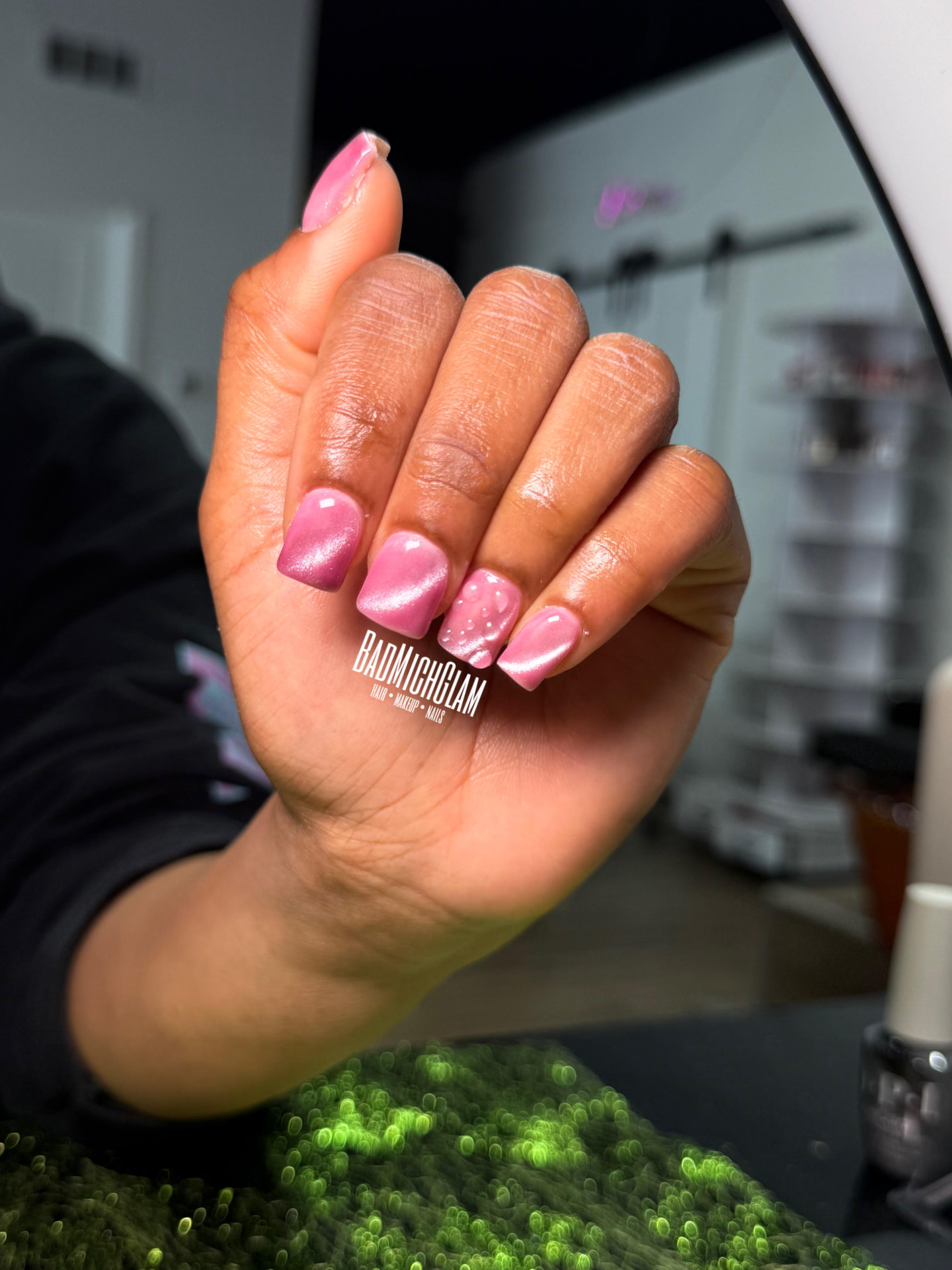 Glossy pink square nails with one textured accent nail